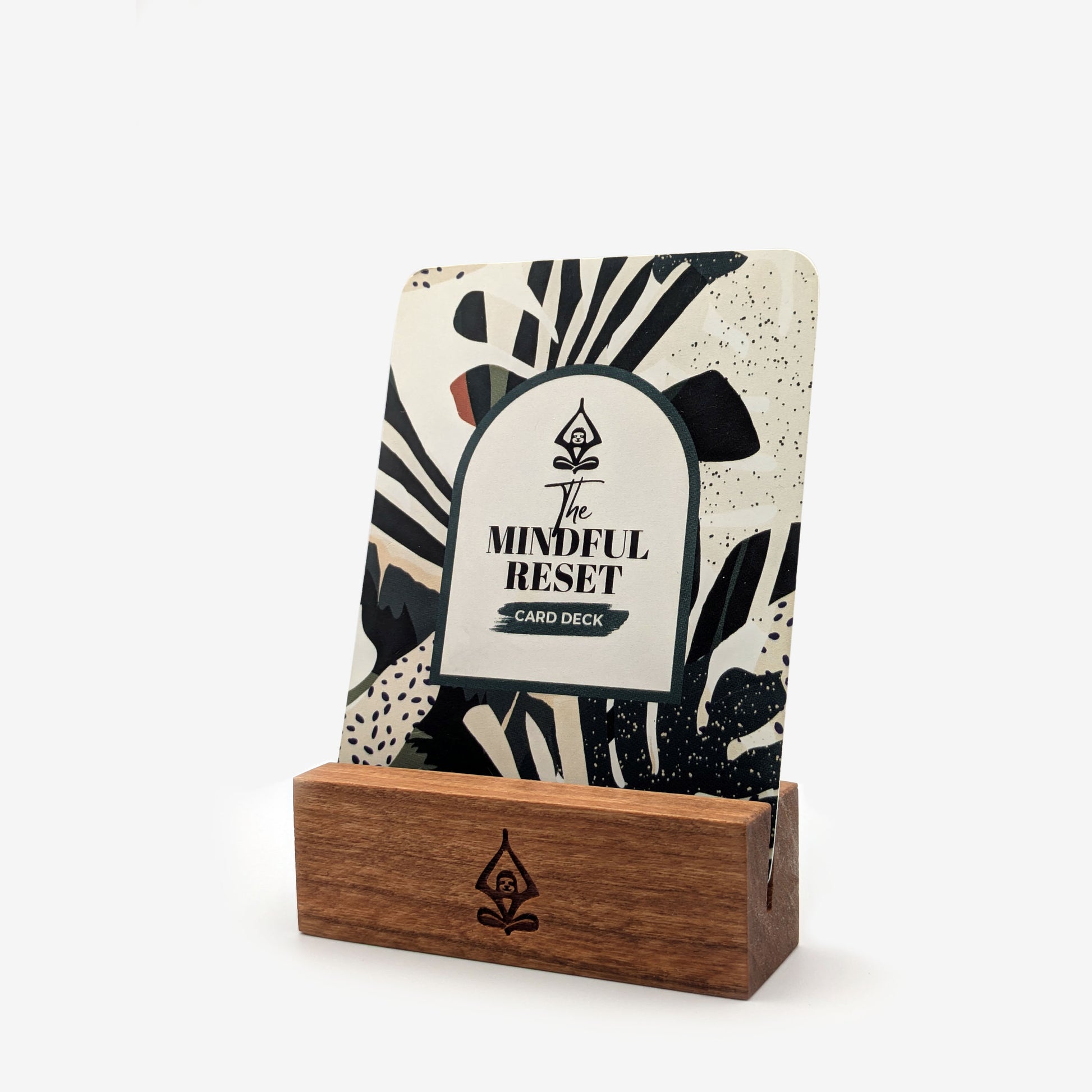 A mindful card deck with guided practices for stress relief and daily calm called 'The Mindful Reset' displayed in a handcrafted natural cherry wood card stand